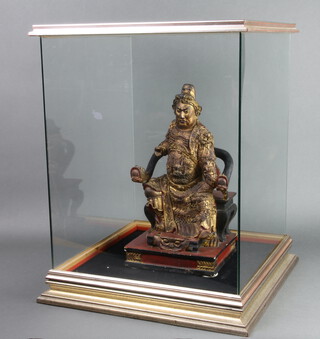 A Chinese carved hardwood figure of a seated immortal on a judgement throne 40cm h x 21cm w x 19cm, contained in a glazed cabinet 59cm h x 46cm w x 46cm d 