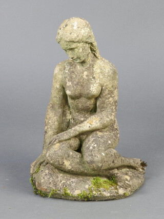 A well weathered reconstituted stone figure of a crouching girl 45cm h x 28cm w x 23cm d 