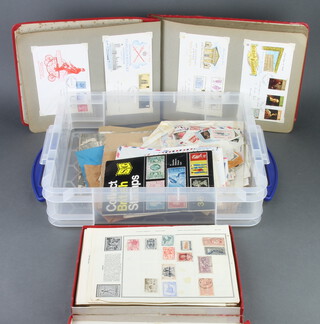 A red album of Elizabeth II GB first day covers, a collection of world stamps on sheets, loose stamps etc