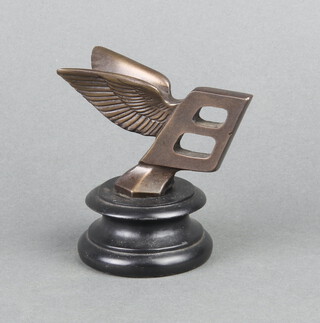 A resin facsimile Bentley car mascot, raised on a socle base 9cm h x 5cm 