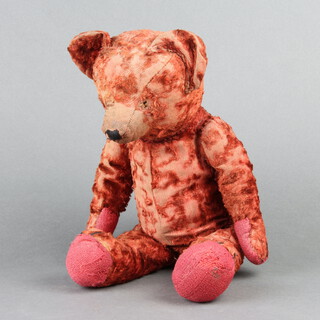A 19th/20th Century red teddy bear with articulated limbs 42cm 