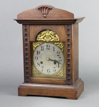 A Continental 8 day striking mantel clock with 15cm arched gilt dial, Arabic numerals and silvered chapter ring, contained in an oak case, complete with pendulum 37cm h x 24cm w x 15cm d 