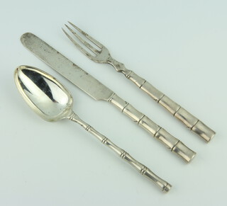 A set of cast silver knife, fork and spoon with bamboo handles, Sheffield 1903, gross weight 128 grams