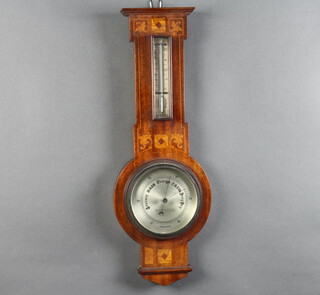 An Edwardian aneroid barometer and thermometer with silvered dial contained in n inlaid mahogany wheel shaped case, the dial marked Thomas Armstrong & Brothers Ltd. Manchester, Liverpool & London no.3402 56cm x 20cm 