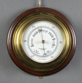 An aneroid barometer and thermometer with enamelled dial contained in a brass case, the dial marked John Barker & Co. Kingston, 8cm x 28cm 