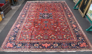 A red and blue ground Northwest Persian carpet with central medallion within a 5 row border 636cm x 437cm 
