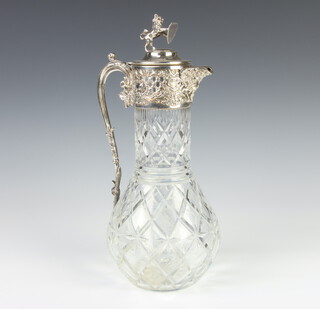 A Victorian silver plated mounted cut glass claret jug with lion finial and vinous decoration 31cm 