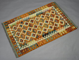 A yellow, turquoise and light brown ground Chobi Kilim with all over geometric design 153cm x 101cm 