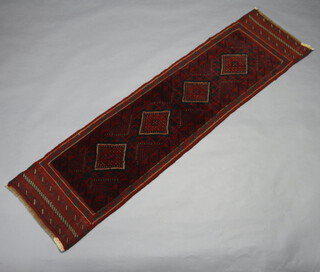 A red and black ground Meshwani runner with 4 stylised diamonds to the centre 299cm x 60cm 