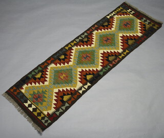 A turquoise, green and brown ground Chobi Kilim runner with all over geometric design 204cm x 61cm 