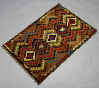 A red, brown and tan ground Belouche rug with diamond geometric design 115cm x 80cm 