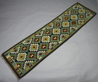 A white, brown and turquoise ground Maimana Kilim runner with overall geometric design 298cm x 79cm 
