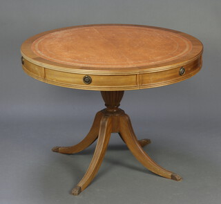A Georgian style oval mahogany pedestal extending dining/boardroom table with inset tooled leather surface and 1 extra leaf, raised on turned column and tripod base 75cm h x 101cm w x 101cm l when closed x 141cm l when extended  