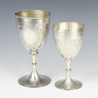 A Victorian silver engraved goblet shaped trophy London 1874, 280 grams 21cm, a ditto 418 grams 24cm 