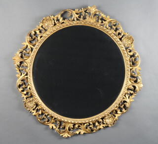 A 19th Century style circular bevelled plate wall mirror contained in a pierced and gilt wooden frame 70cm diam. 