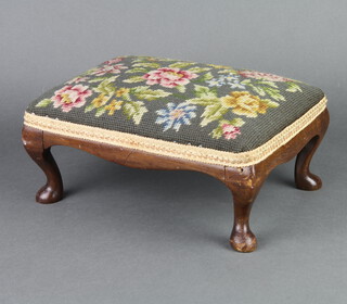 A rectangular Queen Anne style walnut footstool with floral Berlin woolwork seat raised on cabriole supports 12cm x 30cm x 21cm 