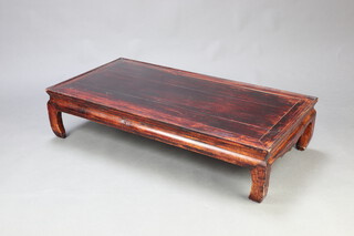 A rectangular Chinese hardwood opium table raised on shaped supports 27cm h x 116cm w x 60cm d 