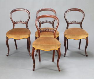 A set of 4 Victorian mahogany balloon back dining chairs with carved shaped mid rails and over stuffed seats, raised on cabriole supports 85cm h x 45cm x 40cm d (seat 31cm x 26cm) 