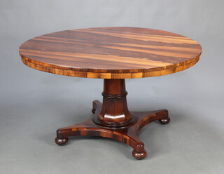 A circular William IV rosewood snap top dining table raised on turned column, triform base and bun feet 74cm h x 136cm diam. 