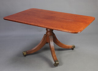 A rectangular Regency mahogany snap top breakfast table raised on a pillar and tripod column ending in brass caps and casters 71cm h x 138cm w x 88cm d