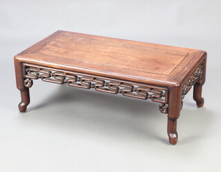 A rectangular Chinese hardwood opium style coffee table, raised on shaped supports 28cm h x 75cm w x 40cm 