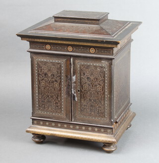 A Moorish, wire inlaid hardwood collectors cabinet, fitted 8 short drawers enclosed by a pair of panelled doors, raised on bun feet 40cm h x 27cm w x 21cm d 