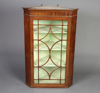 A Georgian mahogany corner cabinet with moulded cornice, fitted shelves enclosed by an astragal glazed panelled door 111cm h x 71cm w x 49cm d 