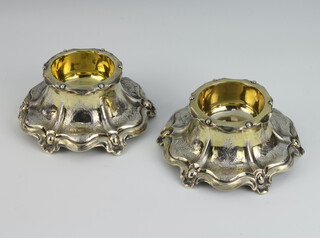 A pair of Victorian cast silver table salts with gilt interiors and scroll decoration on scroll feet London 1847, 346 grams, 12cm 