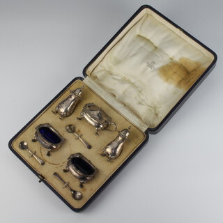 A silver 5 piece condiment set with spoons on pad feet Birmingham 1929 and 1930, 198 grams, cased 