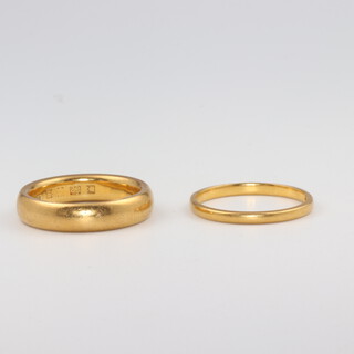 Two, 22ct yellow gold wedding bands, size N and N 1/2, 11 grams 