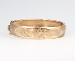 A 9ct yellow gold etched bangle, gross weight 13 grams