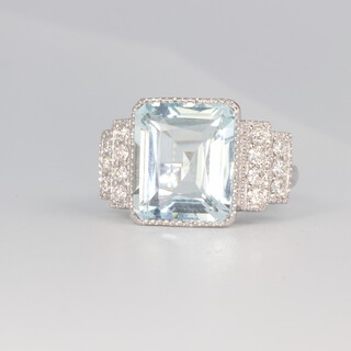 An 18ct white gold Art Deco style aquamarine and diamond ring, the centre stone approx. 7.93ct, the brilliant cut diamonds to the shoulders approx. 0.5ct, size N, 8.2 grams 
