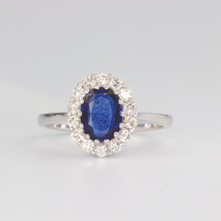 An 18ct white gold oval Kyanite and diamond oval cluster ring, the centre stone approx. 1.29ct, the brilliant cut diamonds 0.52ct, size N, 3.4 grams 