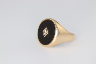 A gentleman's 9ct yellow gold onyx and diamond signet ring, 6.9 grams gross, size O 