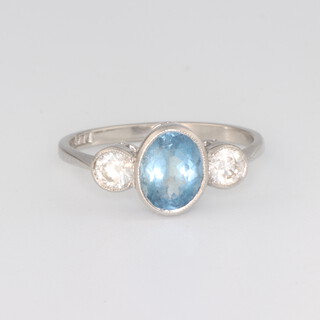 A platinum oval aquamarine and diamond 3 stone ring, the centre stone 1.25ct, the 2 brilliant cut diamonds 0.45ct, size O, 3.2 grams 