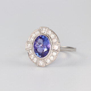 A platinum Edwardian style oval tanzanite and diamond ring, the centre stone 1.35ct, the brilliant cut diamonds 0.54ct, size N 1/2, 4.8 grams 
