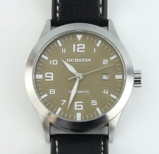 A gentleman's steel cased Ochstin automatic calendar wristwatch contained in a steel case on a leather strap 