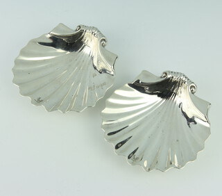 A pair of Victorian cast silver butter dishes in the form of shells, raised on shell feet, London 1875, 11cm, 216 grams