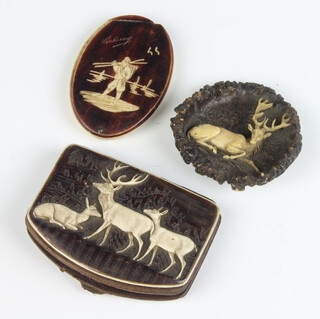 A carved antler horn brooch depicting a reclining deer, a mounted purse and an oval mirror 