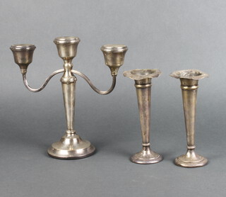 A silver 3 light candelabrum of tapered form, Birmingham 1971, 24cm together with 2 tapered silver posy vases (both a/f)