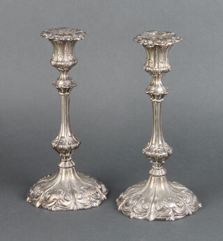 A pair of silver plated cast Rococo style candlesticks with scroll decoration 25cm 