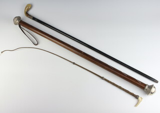 An ebonised walking cane with silver collar Birmingham 1923, a riding crop and a Gucci metal mounted wood letterack 