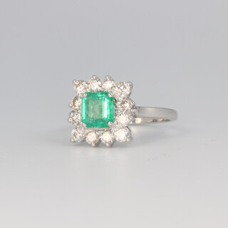 An 18ct white gold square cut emerald and diamond cluster ring, the centre stone 1.11ct, the brilliant cut diamonds 0.92ct, 4.5 grams, size O