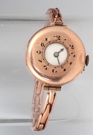 A lady's 9ct yellow gold half hunter wristwatch with ditto sprung bracelet, gross weight including movement 19.9 grams  