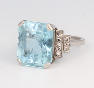 A white metal aquamarine and diamond ring, the rectangular cut stone 15mm x 12mm with 10 brilliant cut diamonds, each approx, 0.01ct, gross weight 7.2 grams, size M 1/2
