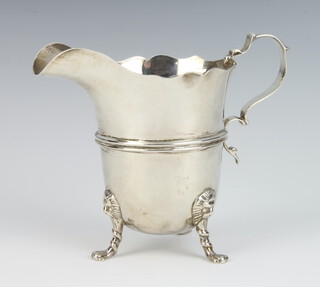 A silver cream jug with ribbed decoration on lion knees with claw feet, 122 grams, 10cm, marks are rubbed 