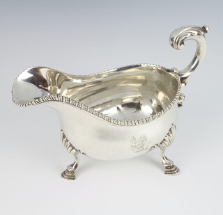 A George III silver sauce boat with gadrooned rim and S scroll handle, raised on hoof feet, London 1771, 388 grams 