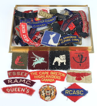 A quantity of Second World War Army cloth badges including Royal Sussex, The Westminster Regiment Canada etc 