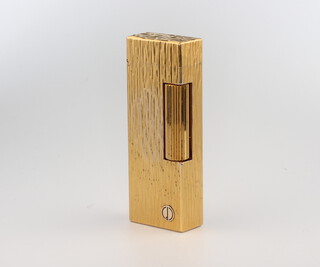A gentleman's bark finished gold plated Dunhill cigarette lighter boxed