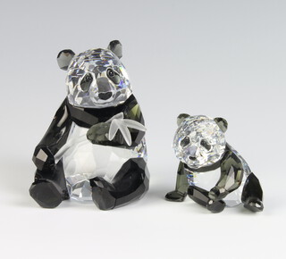 A Swarovski Crystal Society figure of a seated panda holding bamboo 9cm and a ditto cub 5cm, boxed 